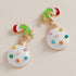 Colorful Christmas ornament earrings on a beige background