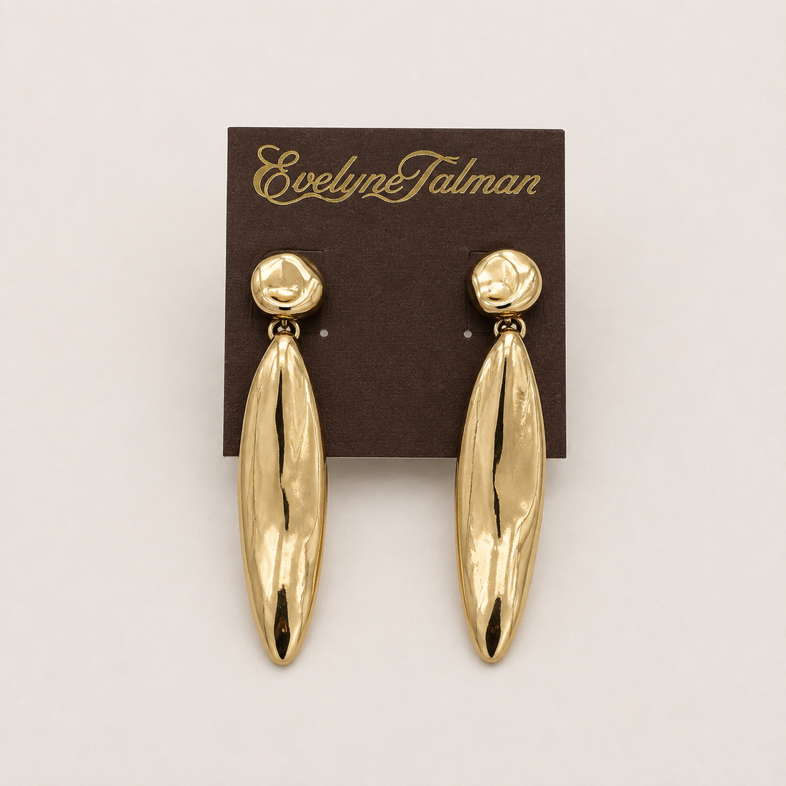 A pair of gold drop earrings with textured teardrop-shaped dangles and round stud top.