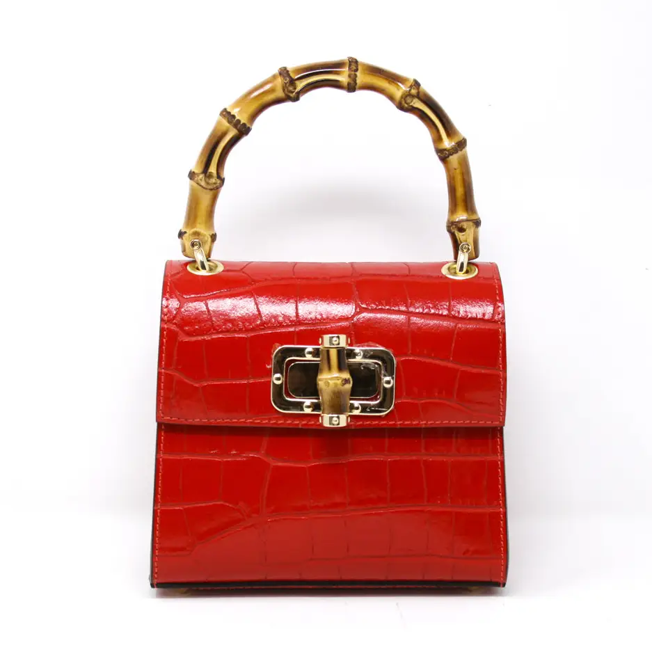 Women’s red handbag with gold  details and bamboo handle 