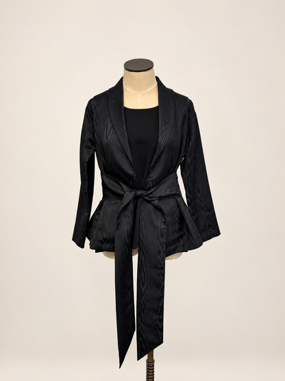 A woman modeling a black satin-like wrap coat J&