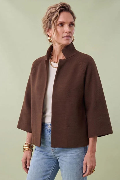 A woman modeling a brown cropped cape jacket with wide three-quarter sleeves by Jenvie The Bristol Jacket in French Toast Chocolate Brown