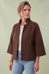 A woman modeling a brown cropped cape jacket with wide three-quarter sleeves by Jenvie The Bristol Jacket in French Toast Chocolate Brown