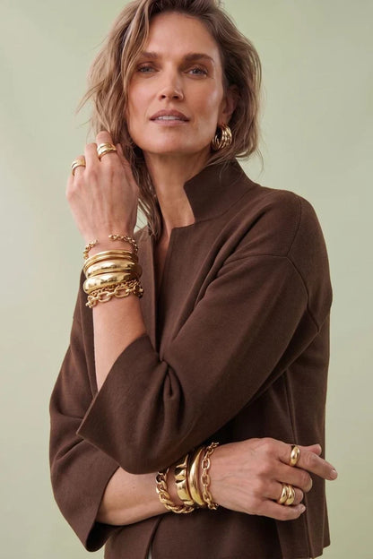 A woman modeling a brown cropped cape jacket with wide three-quarter sleeves by Jenvie The Bristol Jacket in French Toast Chocolate Brown