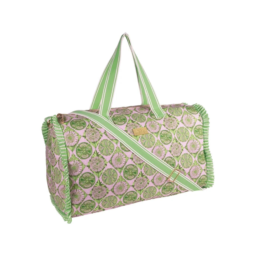 A Lilly Pulitzer Duffle Tote, Tropical Tiles tote bag with a green and pink citrus slice pattern, featuring pale green handles and a small gold-tone Lilly Pulitzer logo plaque. 