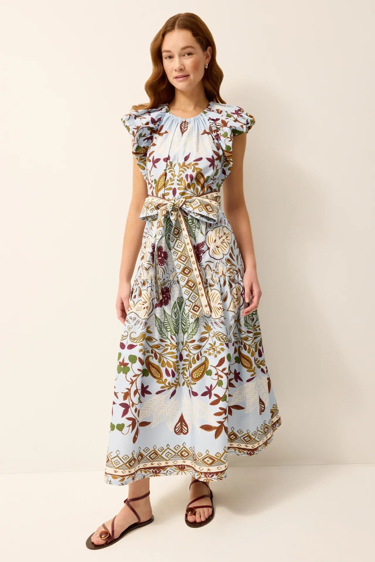 Marie Oliver Leena Dress displayed on a hanger, showcasing its elegant design and fabric details.