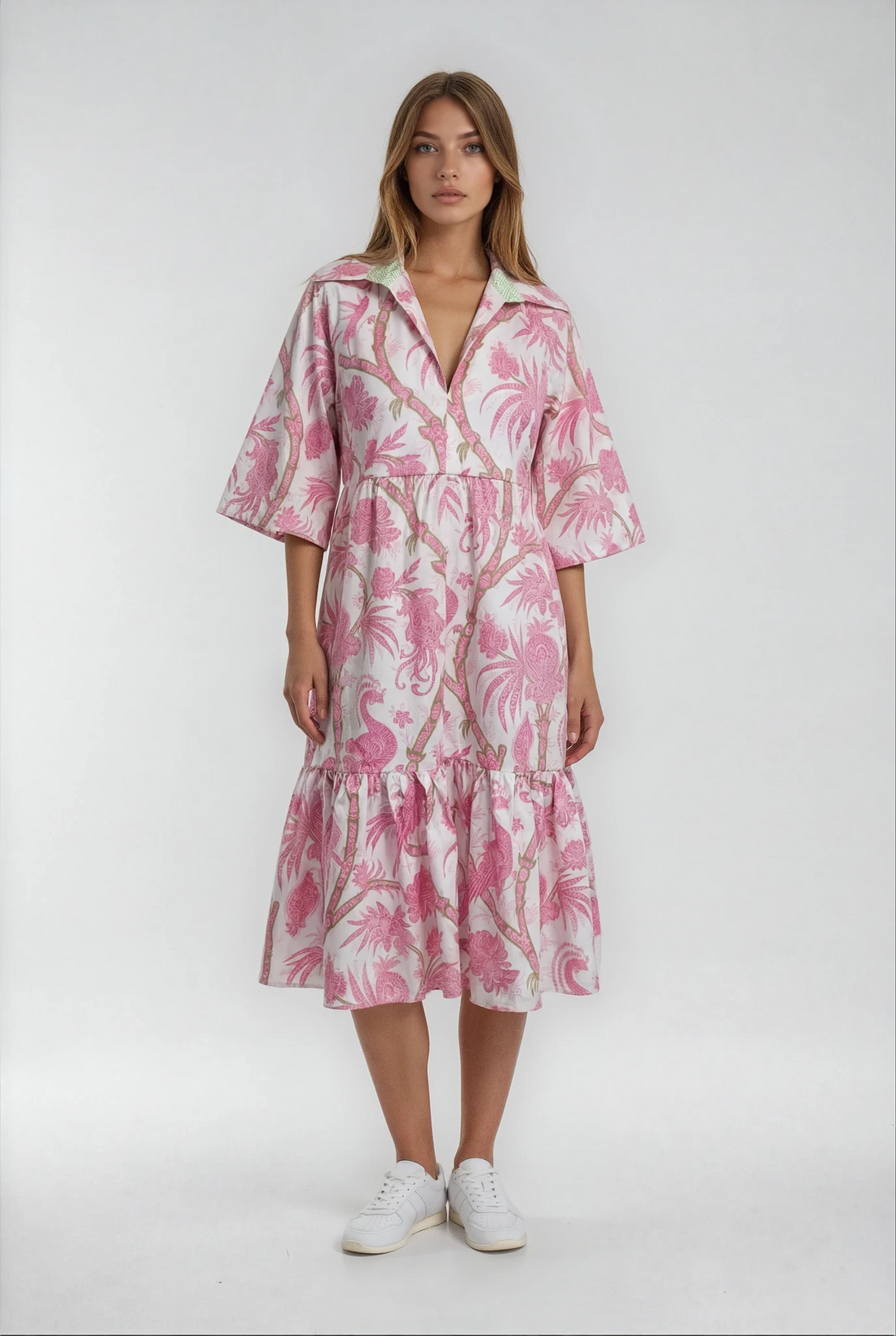 Woman wearing a pink floral dress on a white background