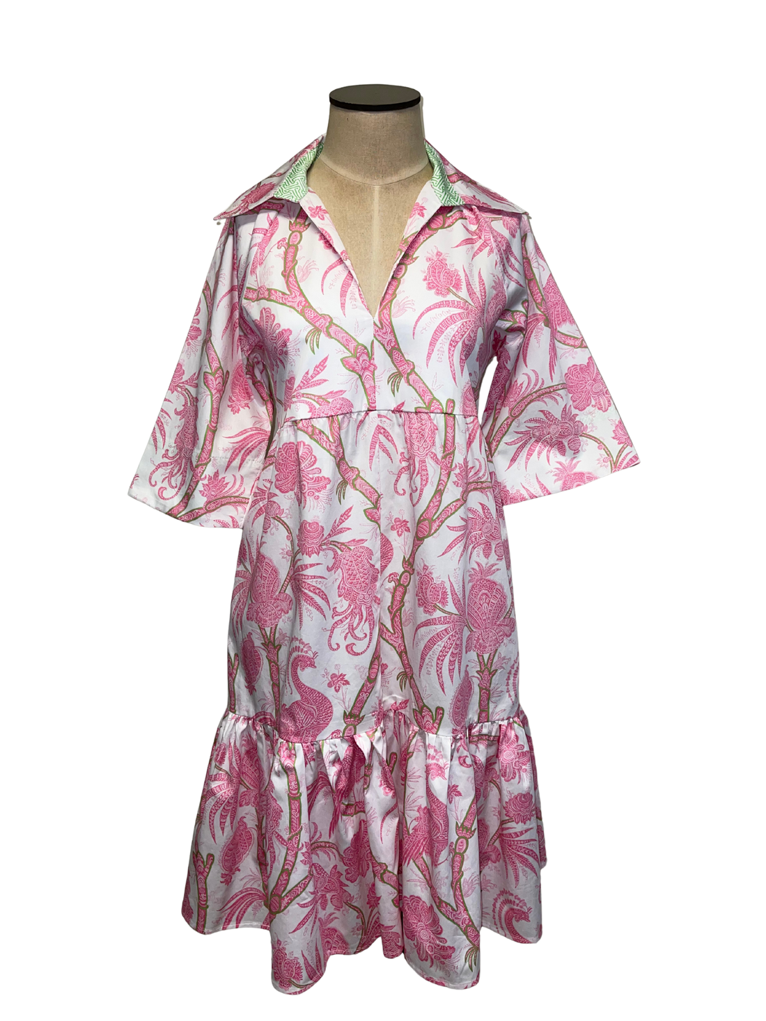 Pink and white floral dress on a mannequin against a white background