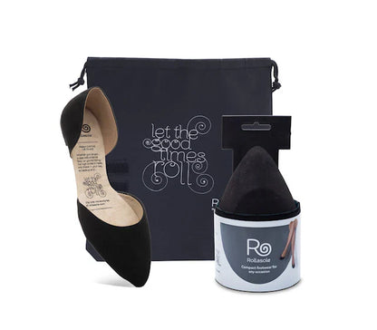 Black high-heeled shoe, black pouch with text, and white container with branding on a white background