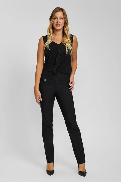 Woman wearing a black sleeveless top and black pants on a gray background