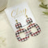 Red Black Gingham Earrings UGA Georgia a pair of square drop earrings with a red, gray, and white plaid pattern, hanging from gold-tone posts on a white display card labeled &