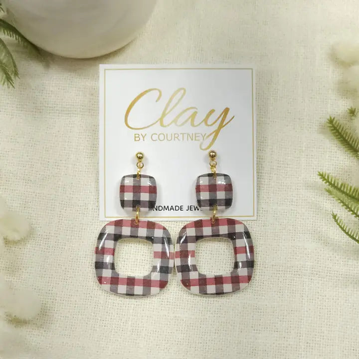 Red Black Gingham Earrings UGA Georgia a pair of square drop earrings with a red, gray, and white plaid pattern, hanging from gold-tone posts on a white display card labeled &