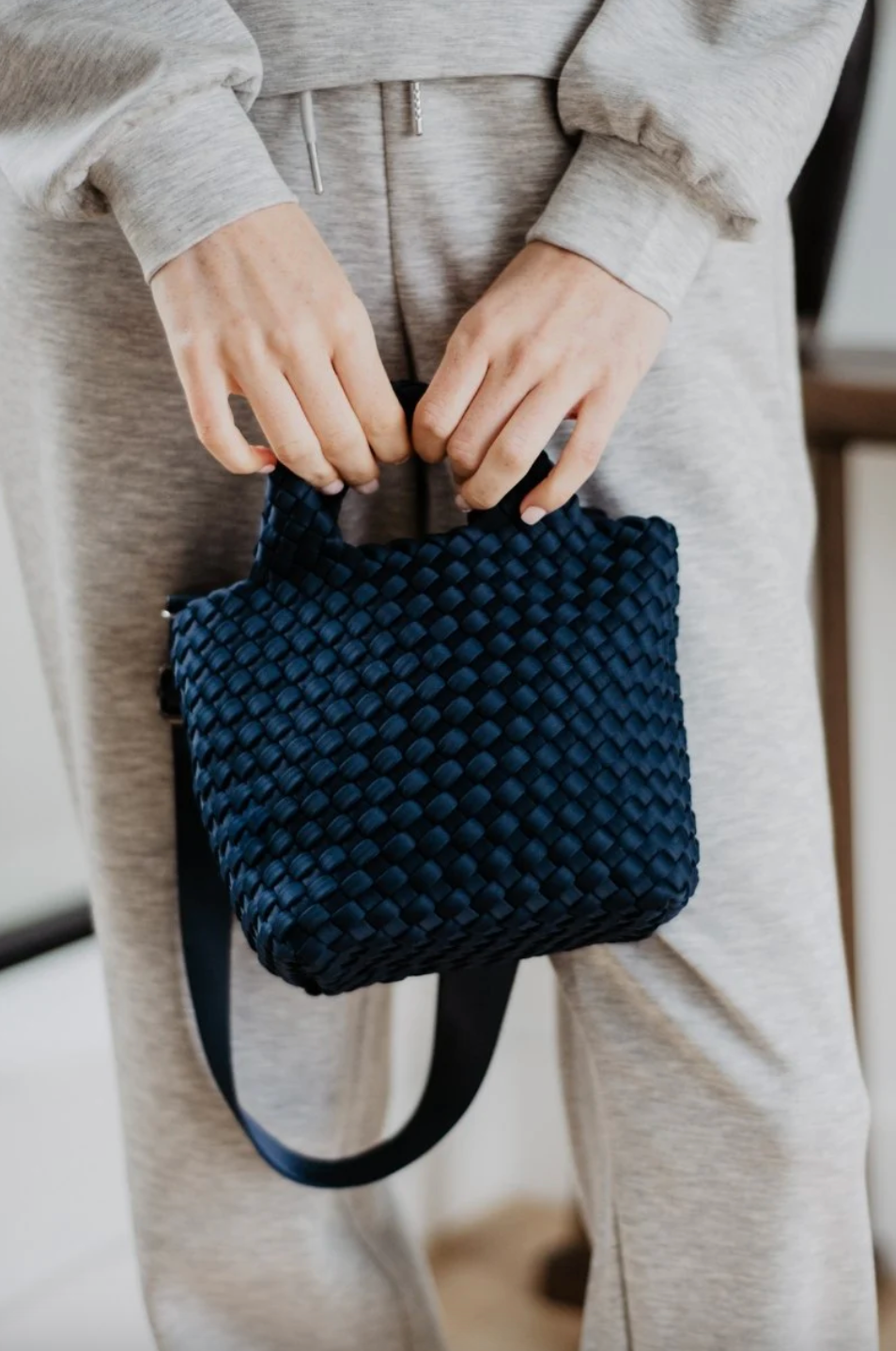 KATYDID neoprene braided clutch bag with textured strap and sleek design, ideal for stylish occasions.