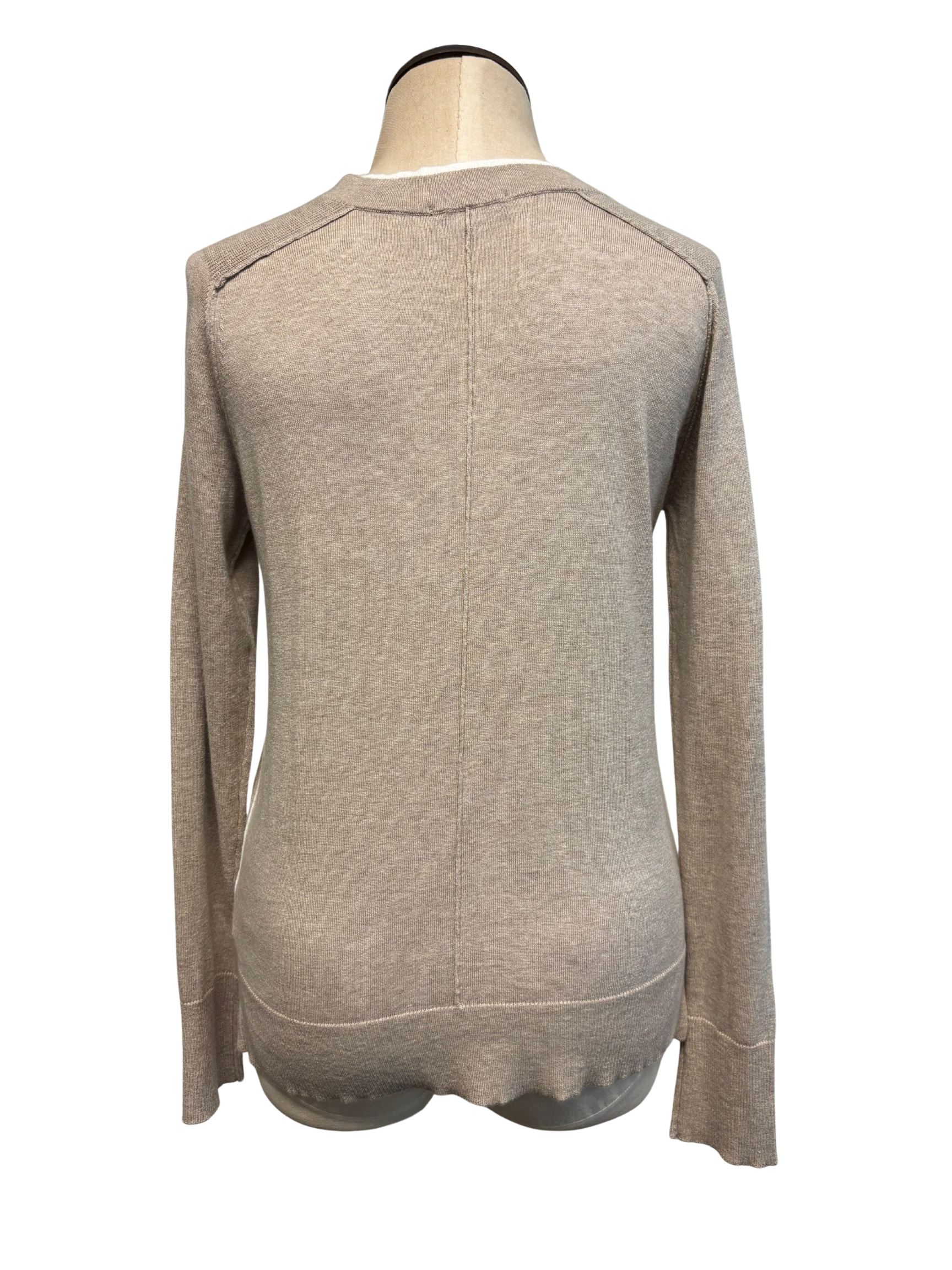 Beige sweater on a mannequin against a white background