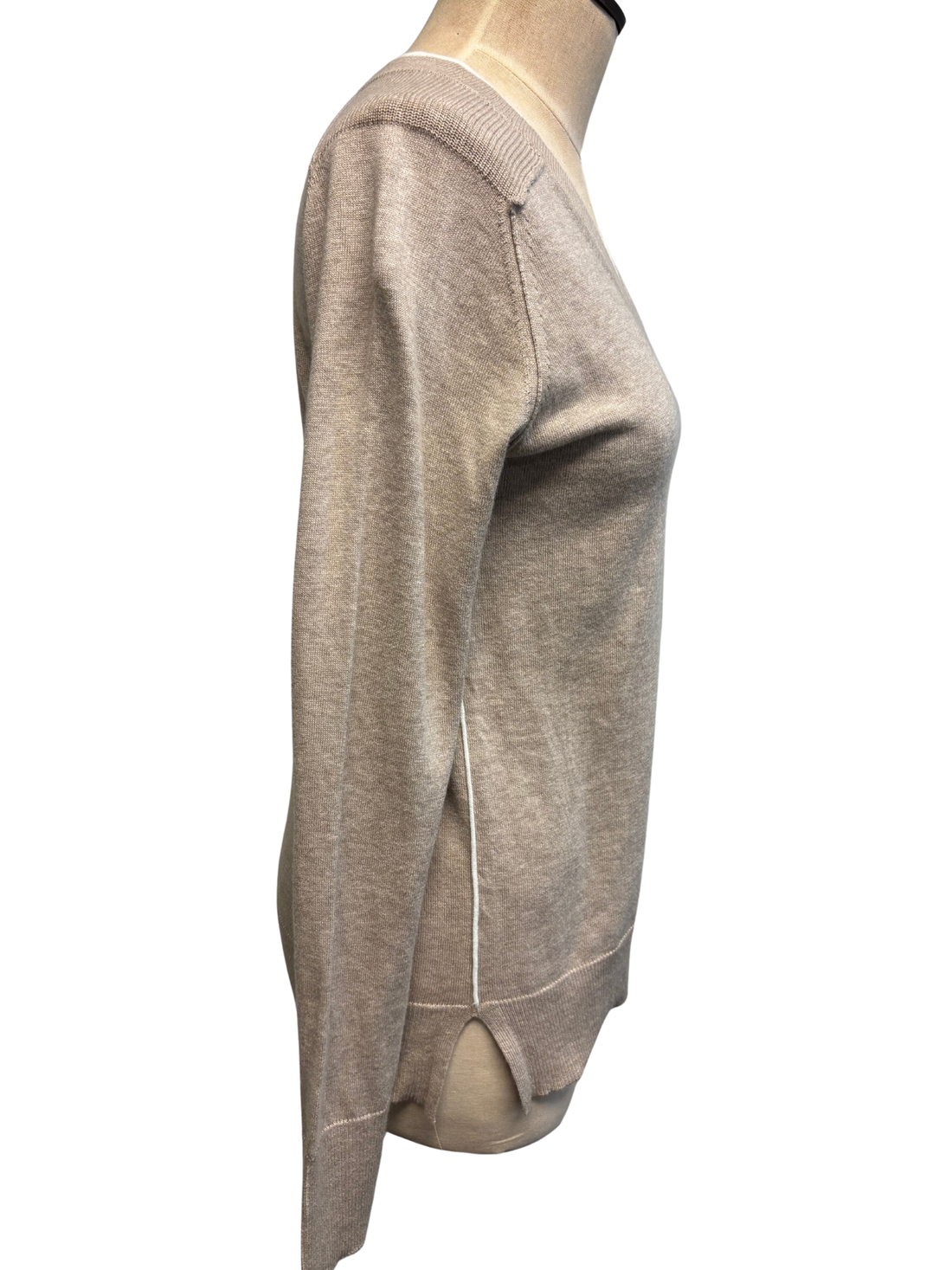 Beige sweater on a mannequin against a white background