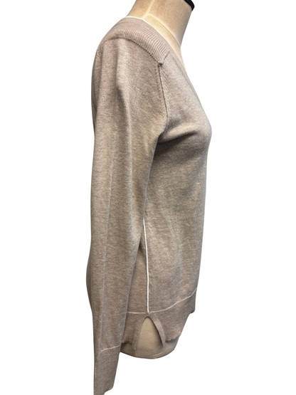 Beige sweater on a mannequin against a white background