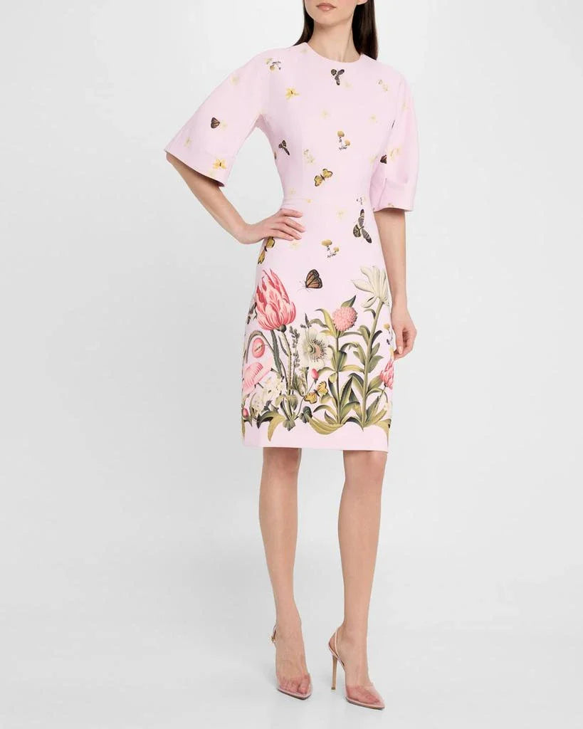 Woman wearing a pink dress with floral and butterfly pattern