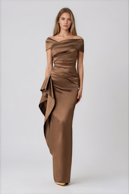 A woman modeling a floor-length off-the-shoulder gown in a warm brown satin fabric by Teri Jon Stretch Taffeta Asymmetrical Off The Shoulder Side Ruffle Gown ITEM 267008BRZ-0