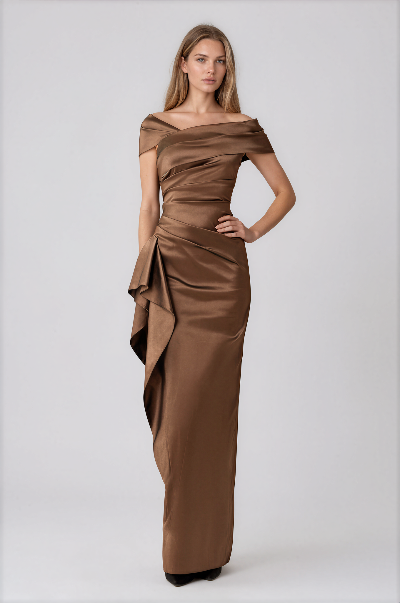 A woman modeling a floor-length off-the-shoulder gown in a warm brown satin fabric by Teri Jon Stretch Taffeta Asymmetrical Off The Shoulder Side Ruffle Gown ITEM 267008BRZ-0