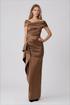 A woman modeling a floor-length off-the-shoulder gown in a warm brown satin fabric by Teri Jon Stretch Taffeta Asymmetrical Off The Shoulder Side Ruffle Gown ITEM 267008BRZ-0