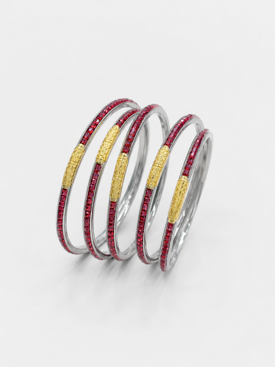 Four stacked silver bangles, each featuring a textured gold center band and a row of small red stones along the outer edge,  UGA Color-Filled Bracelet Set