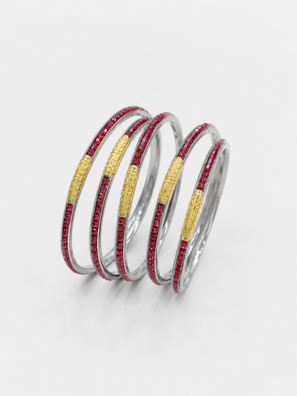 Four stacked silver bangles, each featuring a textured gold center band and a row of small red stones along the outer edge,  UGA Color-Filled Bracelet Set