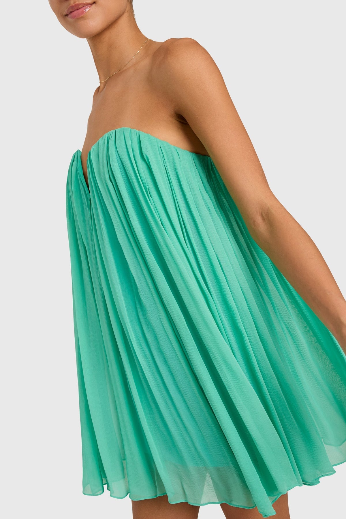 Close-up of the Amanda Uprichard Briella Dress in Caribbean color, showcasing its lightweight fabric and elegant design details.