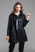 A woman modeling a black leather coat with gold-tone buttons by insight Vegan Leather Car Coat