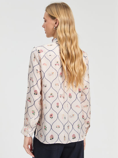 Detail of the illustrated Braserie print on Vilagallo ivory blouse