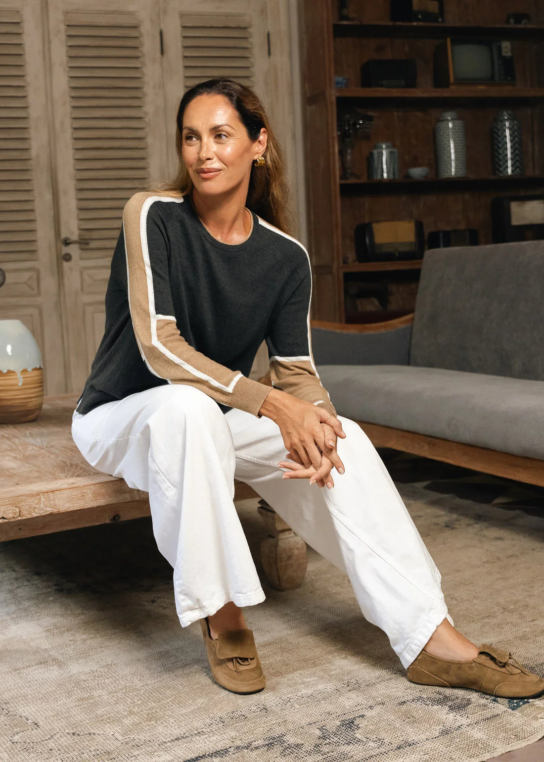 A woman wearing a black long-sleeve top with beige and white sleeve stripes Zaket &amp; Plover Block Play Sweater