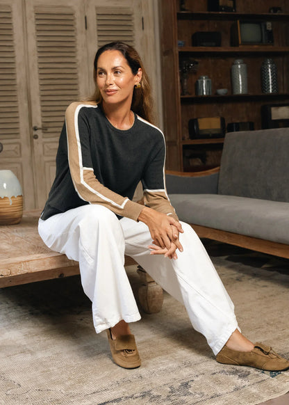 A woman wearing a black long-sleeve top with beige and white sleeve stripes Zaket &amp; Plover Block Play Sweater