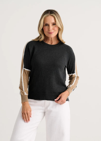 A woman modeling a dark charcoal gray crewneck sweater with beige and white color-blocked sleeves Zaket &amp; Plover
Block Play Sweater