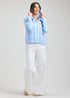 Woman Zaket & Plover light blue jacket and white pants on a plain background