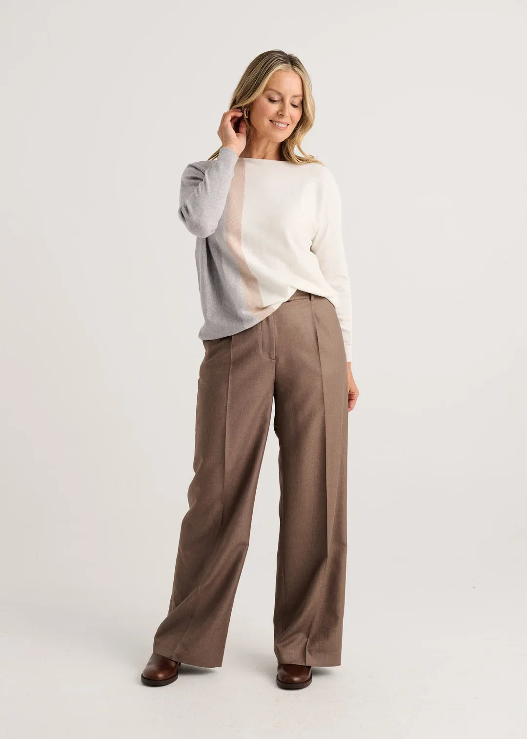 A woman modeling a color-block knit sweater with gray, cream, and beige vertical panels Zaket &amp; Plover Vertical Lines Sweater in Snow