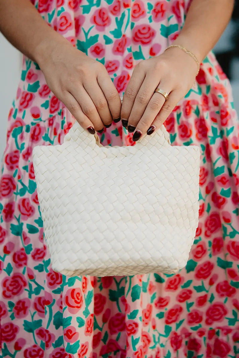White woven neoprene braided clutch bag by KATYDID, stylish handbag with a textured bucket design for everyday use.