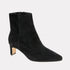 Black suede ankle boots on a light gray background