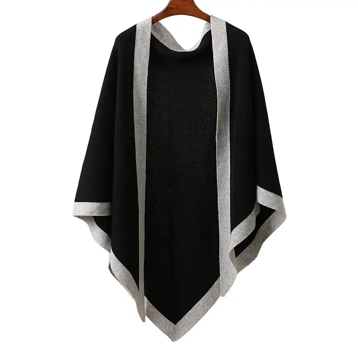 Black poncho with gray trim on a wooden hanger against a white background