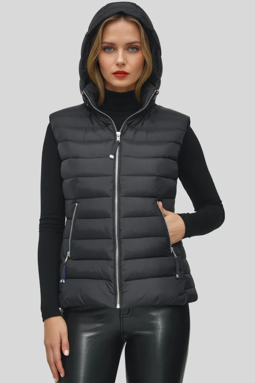 Woman wearing a black puffer vest on a gray background