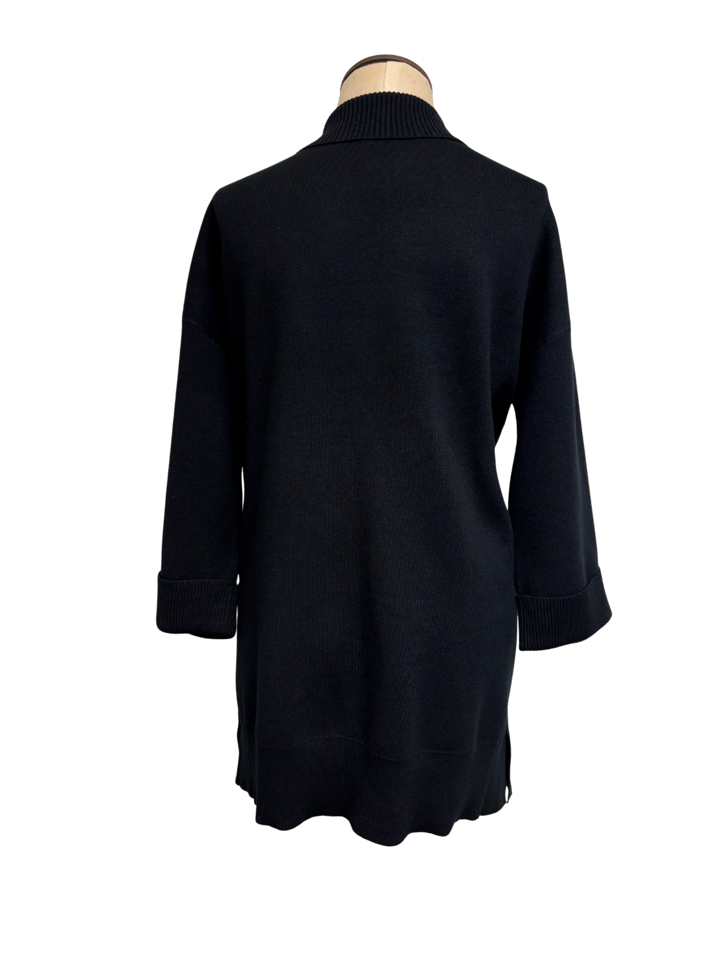 Black cardigan on a mannequin against a white background
