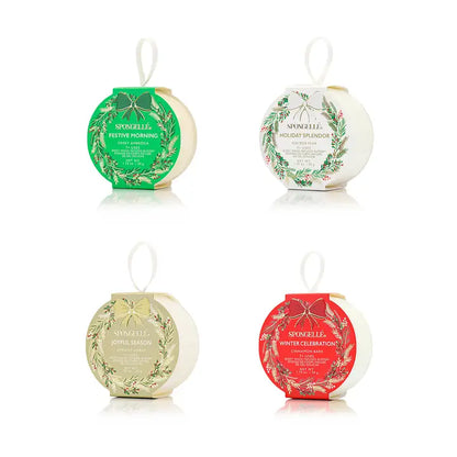 Four Spongelle bath body buffers with decorative labels on a white background