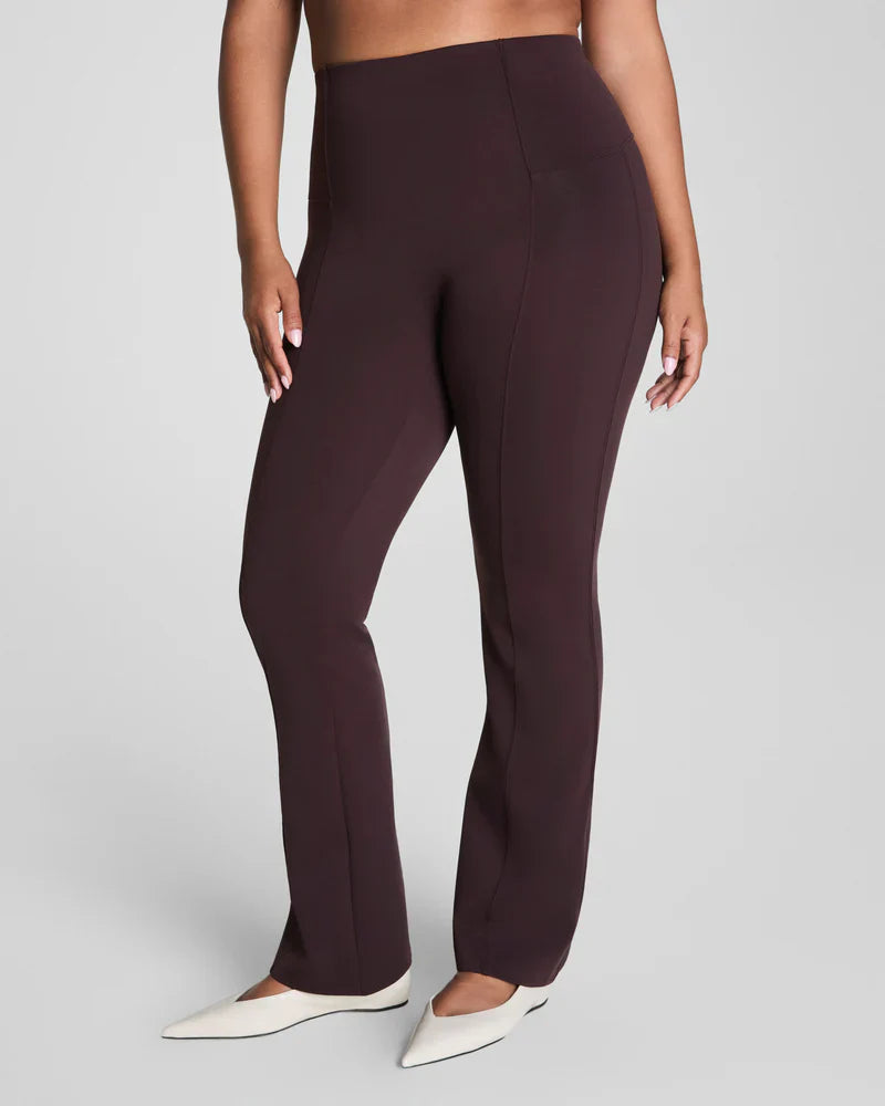 Brown SPANX Dressy Micro Flare Leggings shown on a model, featuring a fitted waistband and stylish flare design.