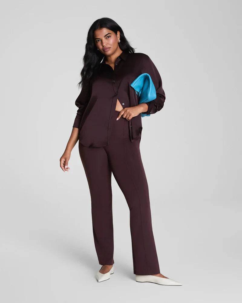 Brown SPANX dressy micro flare leggings shown on a model, featuring a fitted legging style with a subtle flare at the ankle.