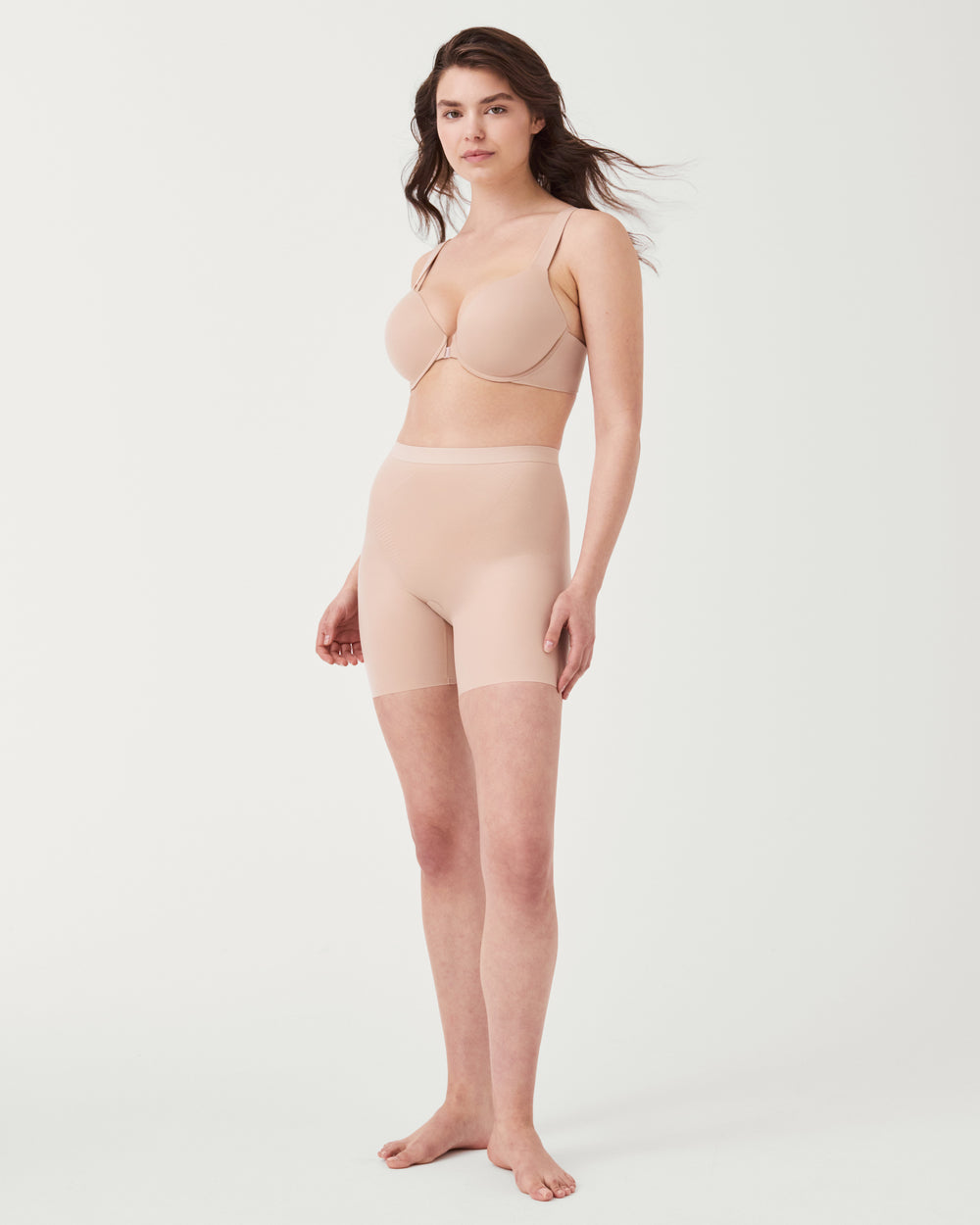 Invisible girlshort lingerie by SPANX, seamless and lightweight, shown in black on a model.