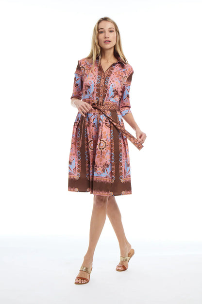 Woman wearing a patterned dress on a white background