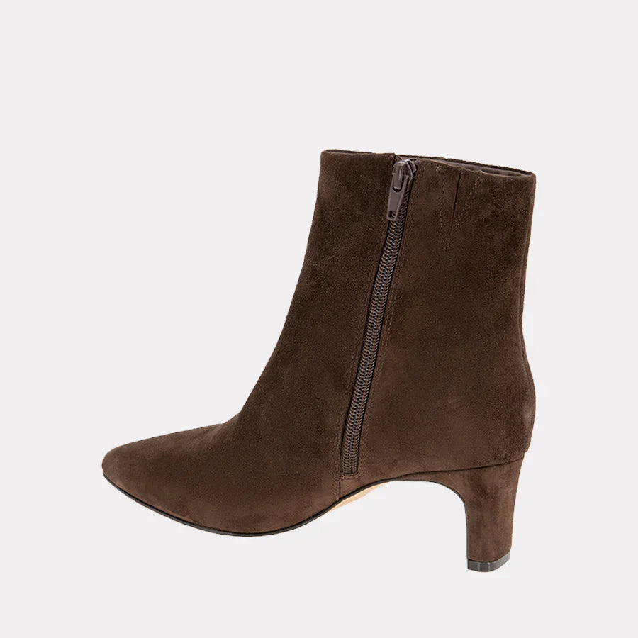 Brown suede ankle boot with a zipper on a light gray background