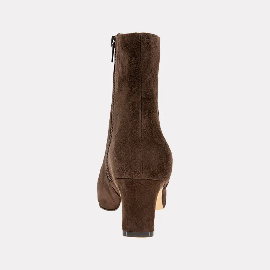 Brown suede ankle boot on a light gray background