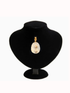 Pearl necklace on a black velvet stand against a white background