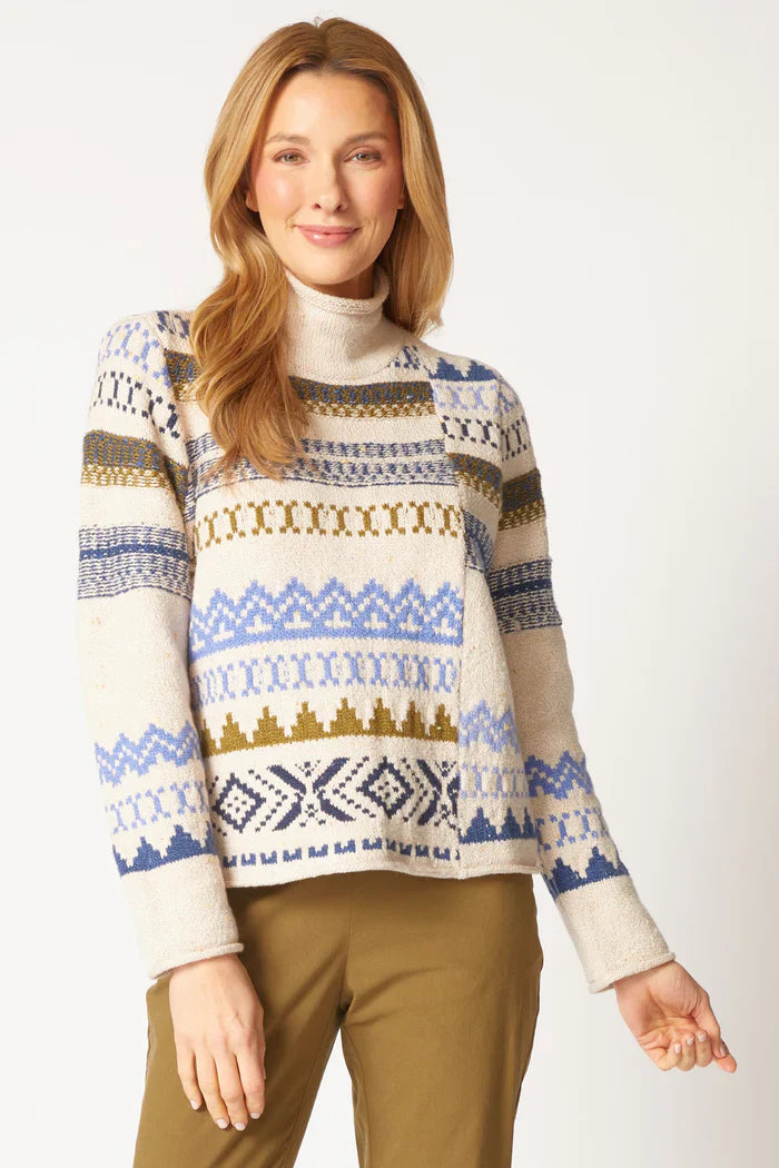 Woman wearing a patterned sweater with a plain background