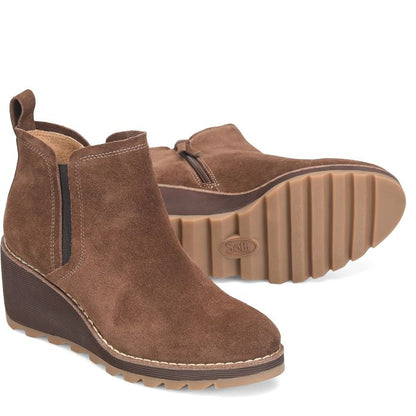 Brown suede wedge ankle boots on a white background
