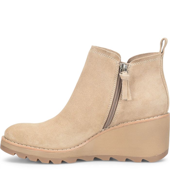 Beige wedge ankle boot with a zipper on a white background