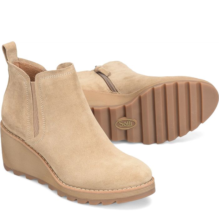 Beige wedge ankle boots with a visible brand logo on a white background